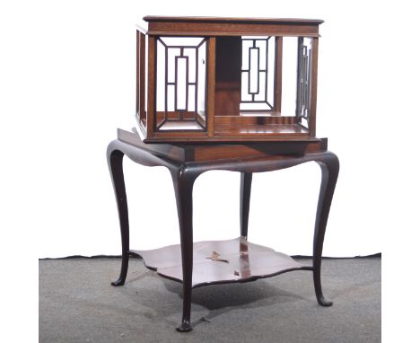 An Edwardian mahogany revolving book rack, fretwork panels, the base with cabriole legs, joined by a shelf, width 48cm, heigh