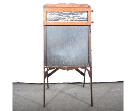A child's chalkboard easel, carved wooden frame, height 120cm.