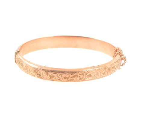 A 9 carat rose gold Victorian style half hinged bangle, 8mm wide hollow section, scroll engraved pattern to front, Birmingham