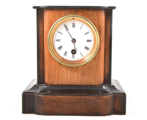 A Victorian walnut and ebonised mantel clock, white circular enamel dial, cylinder movement stamped '1930 44', height 21cm.