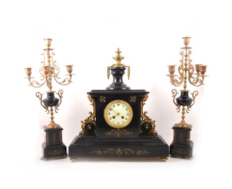 A Victorian slate, marble, and gilt metal clock garniture, the clock case surmounted with an urn, gilt detailing, cream circu