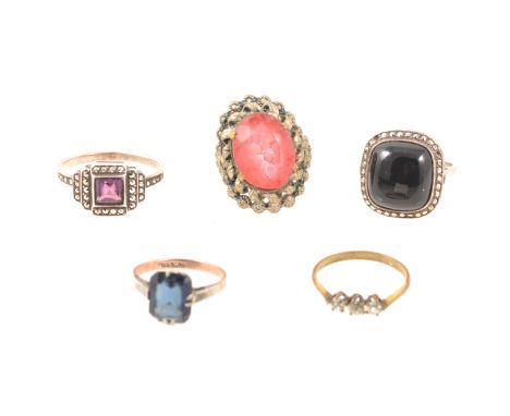 Five vintage dress rings, a cushion shaped white metal cluster set with a cabochon black stone to centre surrounded by marcas