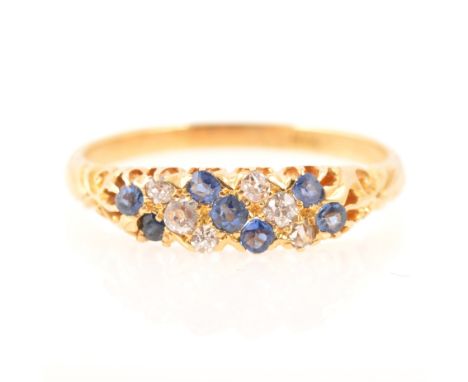 A diamond and blue stone half hoop dress ring, six old and rose cut diamonds and seven untested blue stones claw set in two d