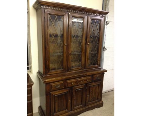 An oak sideboard/display cabinet with lead light glass.