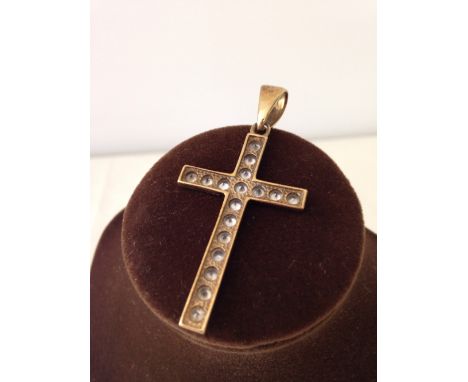 A large gold cross set with white stones measures approx 4cm long or 5.5cm to the top of the ring. Weight approx 4.5g, stampe
