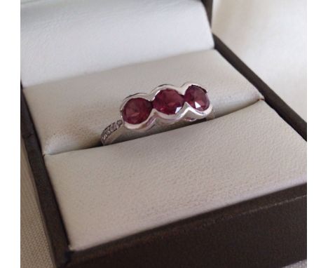 9ct white gold pink tourmaline 3 stone ring with diamond set shoulders. Size N1/2.