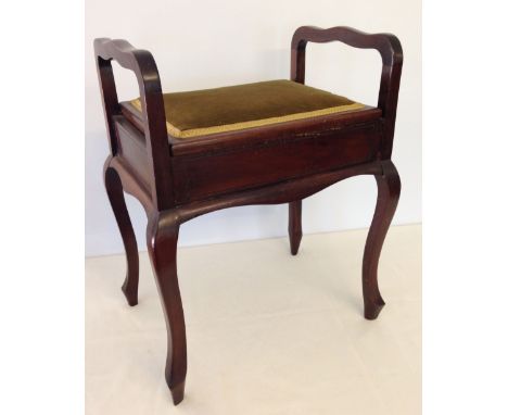 An upholstered piano stool.  