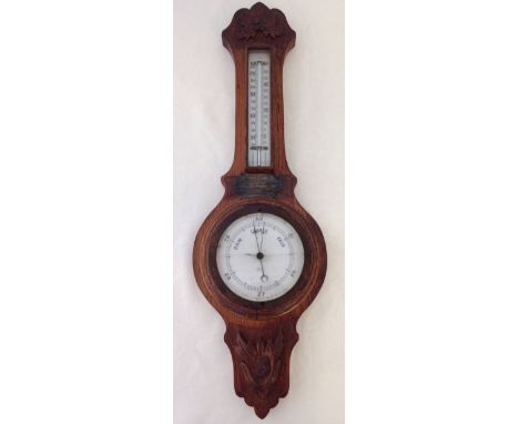 A 1920s carved wood barometer, glass a/f.  
