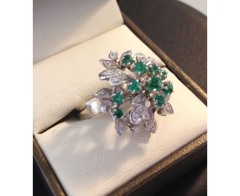 A 14ct white gold diamond & emerald cluster ring set with 22 diamonds and 10 emeralds - size O.  