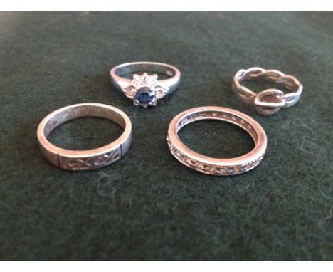 4 silver ladies rings to include an eternity ring.  