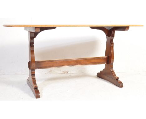 Ercol - A vintage retro mid 20th century Ercol mid-elm dining table. The table having waxed top raised over pierced trestle b