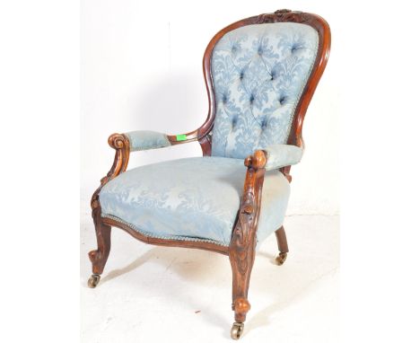 A Victorian 19th century carved wood with upholstered light blue fabric armchair having a a spoon shaped back with carved det