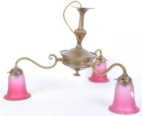 A vintage 20th Century brass ceiling light. Having a circular body, terminating in a finial. Three scrolled brass arms with c