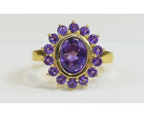 Amethyst Cluster Ring, an oval cut purple amethyst of 2.5cts, bezel set and framed with fourteen round cut matching amethysts