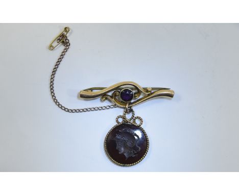 Early 20th Century Bar Brooch. Art Nouveau Bar Brooch with central amethyst, suspending a circular carved intaglio depicting 