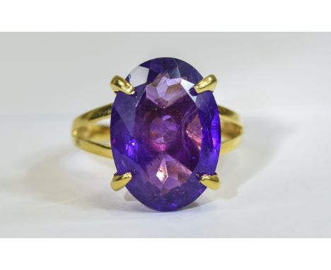 Amethyst Solitaire Ring, 11cts of rich purple amethyst in one oval cut stone, set in a simple but dramatic four prong, 14ct g