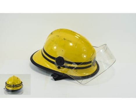 Manchester Fire Brigade Yellow Helmet - yellow with leather inner support, and visor. Brigade badge to front.