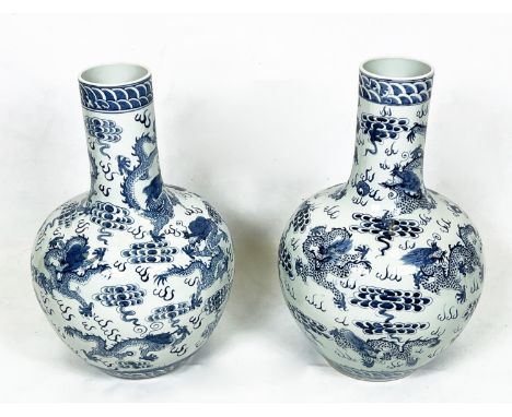 CHINESE BLUE AND WHITE VASES, a pair, painted with dragons chasing the flaming pearl of wisdom, 63cm H. (2) 