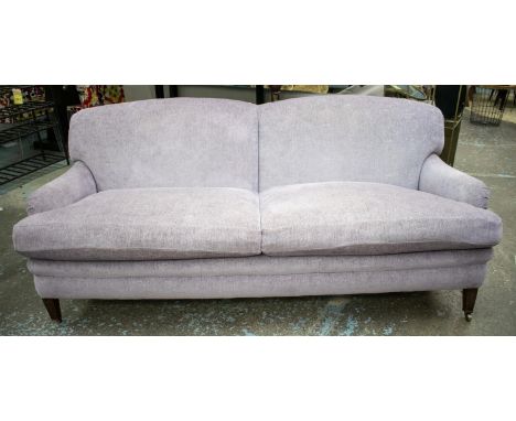 HOWARD STYLE SOFA, 87cm H x 218cm W x 107cm D, in Designers Guild lilac chenille on brass castors. 