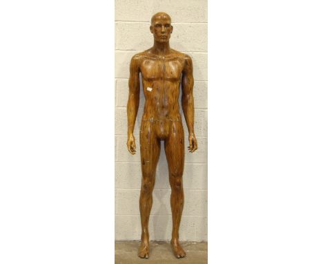 A male shop mannequin of plastic construction, with overall painted wood effect, 188cm.