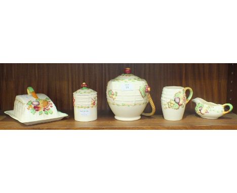 Five pieces of A J Wilkinson Royal Staffordshire pottery with relief-moulded fruit decoration on a cream ground, comprising b