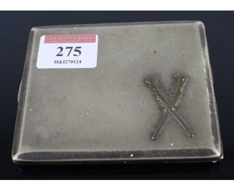 A white metal and engine turned pocket cigarette case, the hinged cover embossed with a pair of shotguns, 9.5cm 