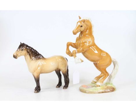 A Beswick model of a rearing horse, model No.1014, h.26cm; together with another Beswick model of a horse, h.18cm, and a Nao 