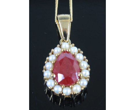 A 9ct yellow gold, ruby and pearl pear shaped cluster pendant, the ruby measuring approx 9 x 6.15 x 3.8mm and estimated as we