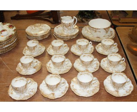 A Charles Wileman florasl decorated part tea service, to include 12 cups and saucers of petal shape, 12 side plates, cream ju