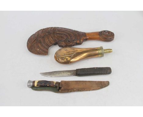 A 19th century copper and brass powder flask together with a Maori type carved wood club and two knives (4)