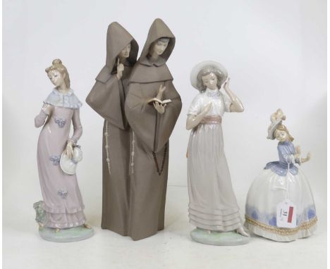 A Lladro bisque porcelain figure group of two nuns reading a book, height 38cm, together with three Nao porcelain figures of 