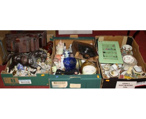Three boxes of miscellaneous items to include a continental mantel clock, ceramics, and a leather clad model of a horse