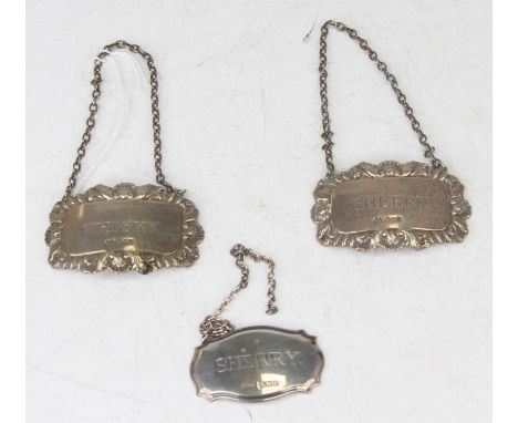 A pair of silver and embossed decanter collars annotated for whisky and sherry, together with one other single one for sherry