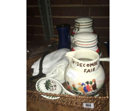 CANE TRAY WITH WIDECOMBE FAIR JUG, GLASS ROLLING PIN, SUGAR &amp; COFFEE JAR &amp; TABLE CLOTH