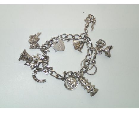 Vintage Silver Charm Bracelet with 10 charms 43gP&P group 1 (£16 for the first item and £1.50 for subsequent items) 