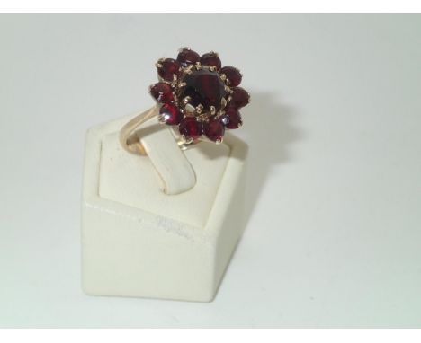 Large 9ct gold garnet set flower-head cluster ring, D: 19 mm, size P, 5.3gP&P group 1 (£16 for the first item and £1.50 for s