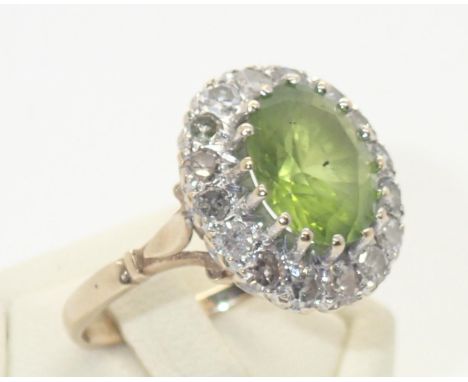 9ct gold cocktail ring set with a large peridot surrounded by diamonds, size R, 5.0gP&P group 1 (£16 for the first item and £