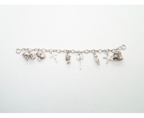 Vintage silver charm bracelet with 8 charms 28gP&P group 1 (£16 for the first item and £1.50 for subsequent items) 