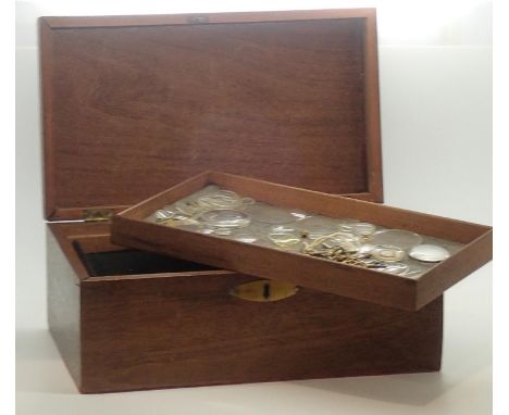 Mahogany collectors box with lift out trays, top tray containing various wrist and pocket watch lenses, parts and 18 pocket w