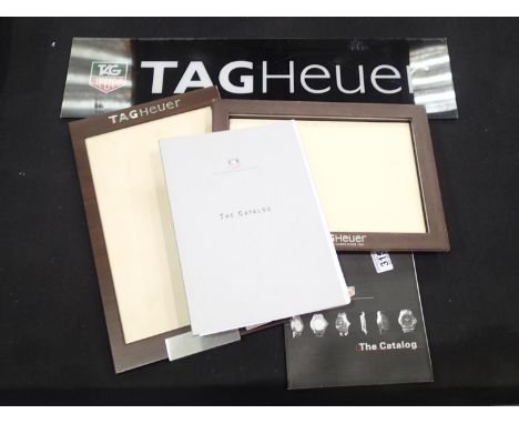 Tag Heuer acrylic shop sign 70 cm x 17 cm, two dealer trays (largest 42 cm x 25 cm) and two Tag Heuer cataloguesP&P group 2 (