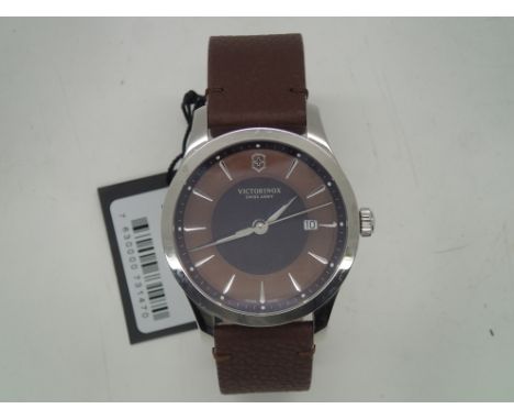 Victorinox Swiss Army wristwatch on leather strap with tag, outer box, papers etc. Working at lotting.P&P group 1 (£16 for th