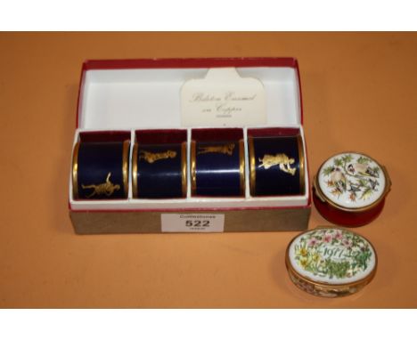 A BOXED SET OF FOUR BILSTON ENAMEL ON COPPER NAPKIN RINGS TOGETHER WITH TWO BILSTON AND BATTERSEA ENAMEL PILL BOXES