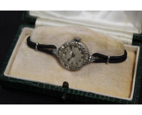 A LADIES VINTAGE PLATINUM AND DIAMOND SET WATCH - EACH BRILLIANT CUT DIAMOND APPROX 0.02 CARATS - TOTAL APPROX 0.60 CARAT
