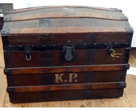 A dome-topped wooden trunk with barrel slats and leather top, initialled "KP" 