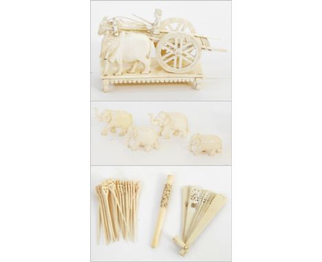 Eastern carved ivory model bullock cart with driver, 12cm wide, four carved miniature ivory elephants, simulated ivory foldin