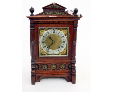 Victorian carved oak and copper-mounted mantel clock in architectural-style case with square brass dial, embossed spandrels a