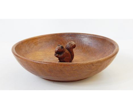A wooden bowl in the style of Mouseman featuring a squirrel 