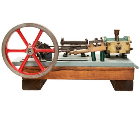 A HEAVY ENGINEERED MODEL OF A HORIZONTAL STEAM ENGINE&nbsp;on a cast iron platform and wooden base, some parts missing and in
