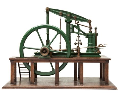 A MODEL OF A 19TH CENTURY BEAM PUMPING ENGINE&nbsp;with large five spoke flywheel mounted on an oak platform with step access