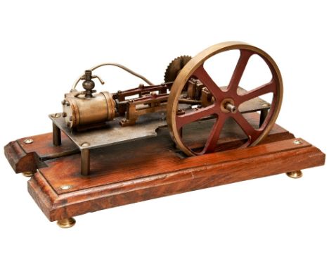 AN ENGINEERED MODEL OF A HORIZONTAL STEAM ENGINE&nbsp;with a sprocket drive wheel. 33 cms long max  PROVENANCE: The David Sta